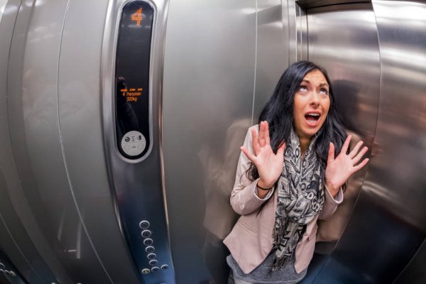 Distorted image of a woman stressed out in an elevator 
