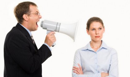 Man yelling at a woman through a megaphone 