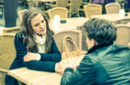 couple-holding-hands-sitting