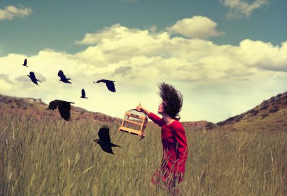 girl freeing birds from cage