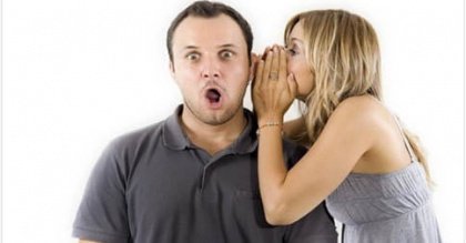 woman telling surprised man a secret