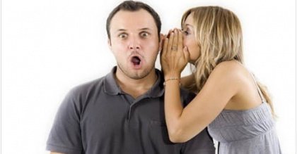 woman telling surprised man a secret