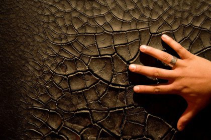 hand-on-cracked-ground