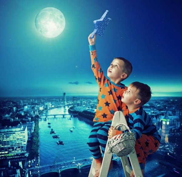 Two boys on a ladder trying to put a star in the night sky 