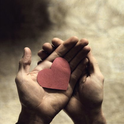 Paper heart in hands