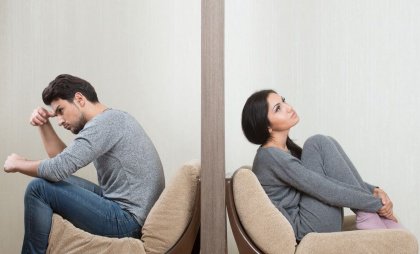 Woman and man on opposite sides of a wall