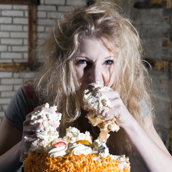 A woman eating sugary foods because she's stressed out.