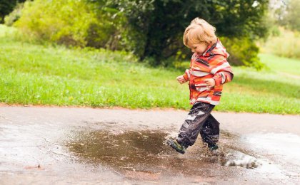 boy jumping puddle