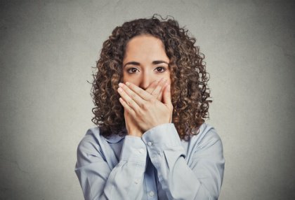 girl covering mouth