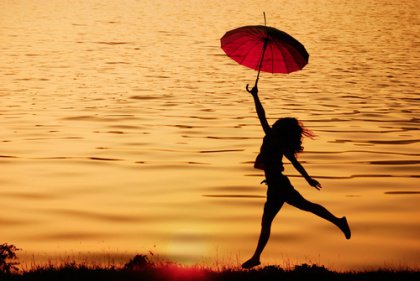 girl jumping with umbrella