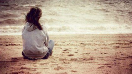 girl sitting at shore