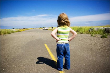 little girl standing on the street