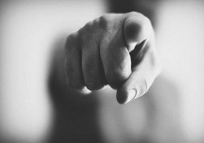 close-up of finger pointing at camera