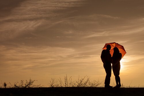 Couple with Umbrella at Sundown