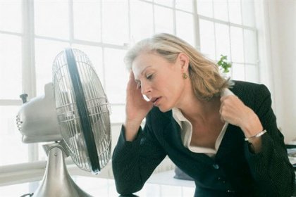 woman in front of fan
