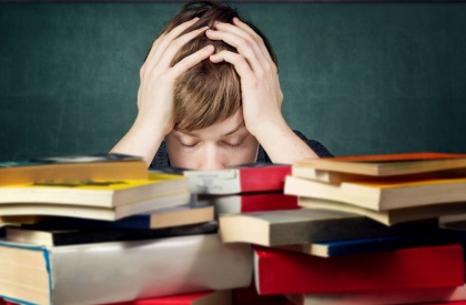Boy Stressed Behind Books