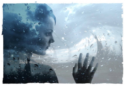 Woman Against Rainy Window