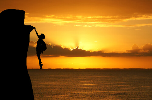 hanging from a cliff
