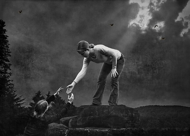 girl reaching for help up