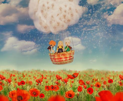 kids in hot air balloon over field reflection