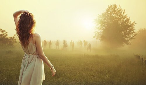 Woman Looking at Figures in Fog