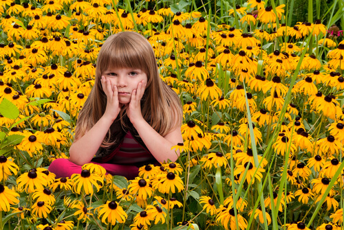 girl sitting in flowers uncomfortable 