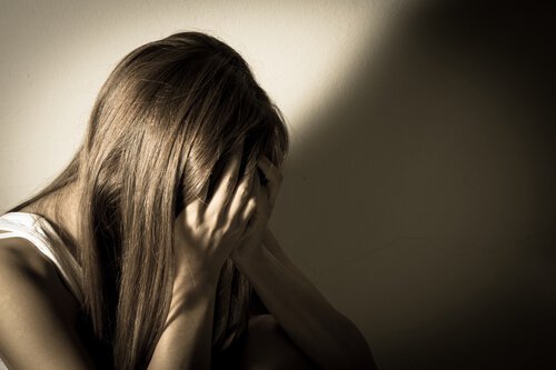 hands covering face