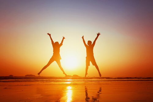 Couple jumping together.