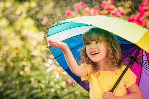 happy girl smiling with a colorful umbrella