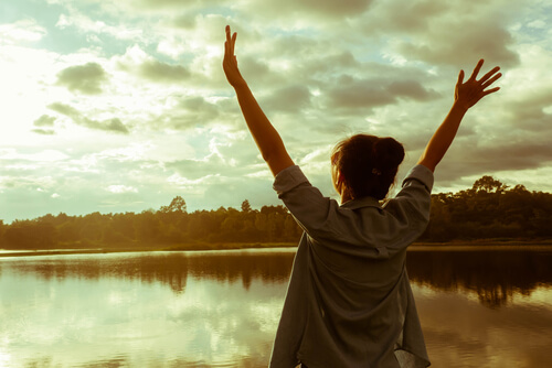 happy woman raising hands