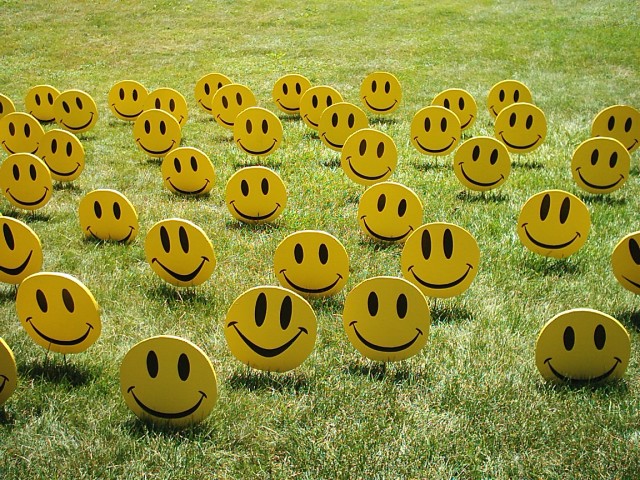 field of smiley faces people 