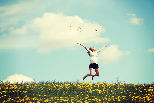 girl jumping in field present