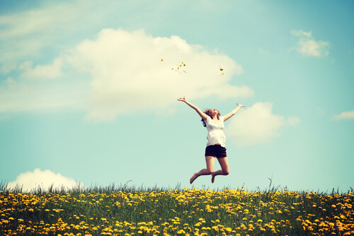 girl jumping in field present