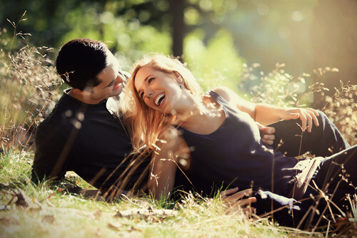 couple laughing on grass bond