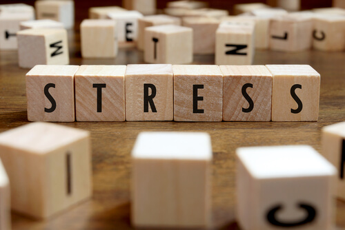 The word "stress" spelled out in wooden blocks.