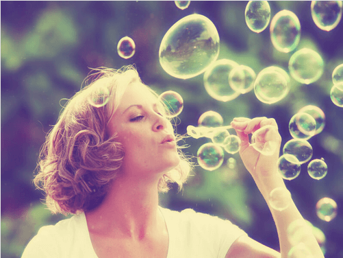 woman blowing bubbles