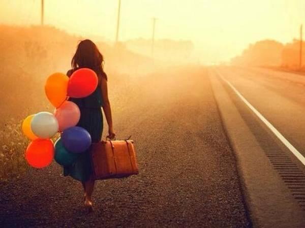 girl walking with balloons alive