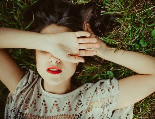 girl laying on grass