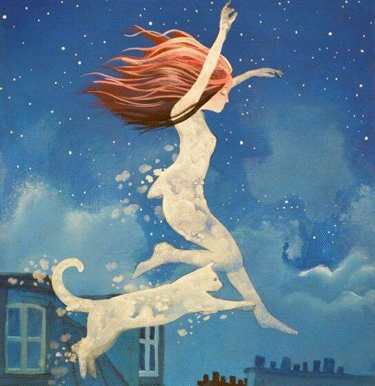 girl with cat enjoying her pet