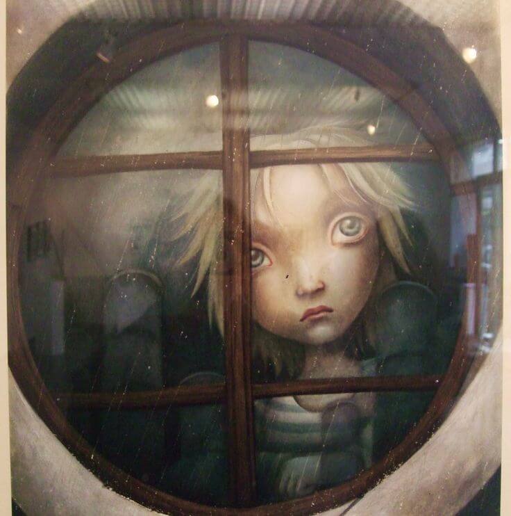 sad boy behind a window