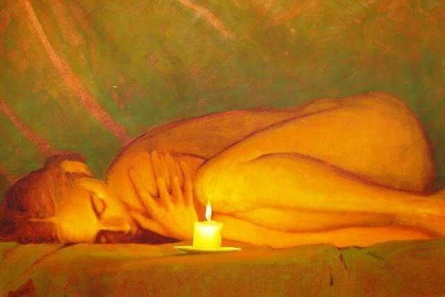 woman laying in front of a candle