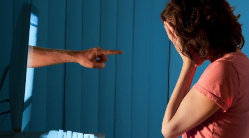 hand from a computer screen pointing at girl