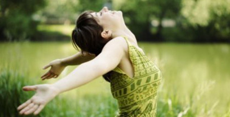 happy girl arms out stretched to the sky