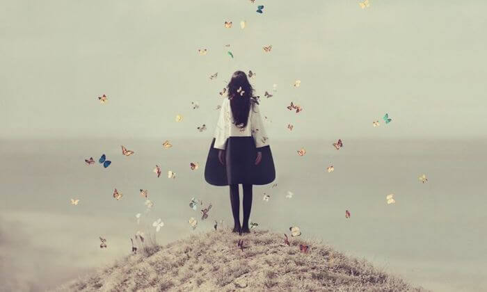young girl surrounded by butterflies