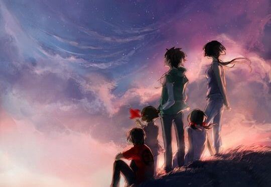 friends on a hill looking at the sunset