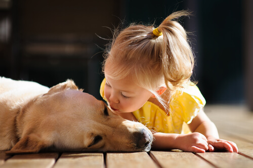 girl blowing a dog a kiss