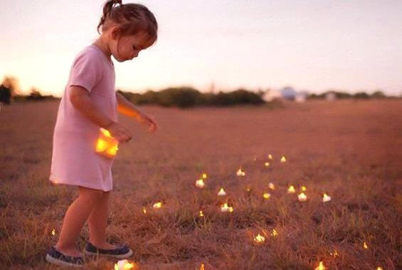 girl picking up lights from the field