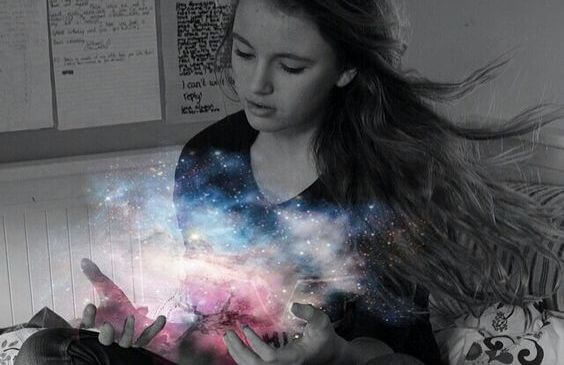 girl with the light of the universe in her hands