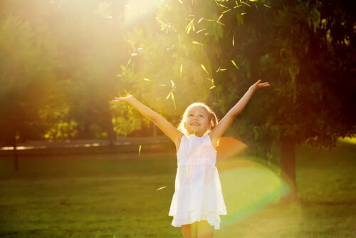happy girl in the field with her arms open