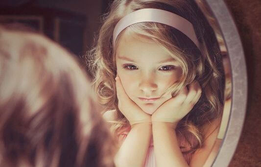 little girl in mirror